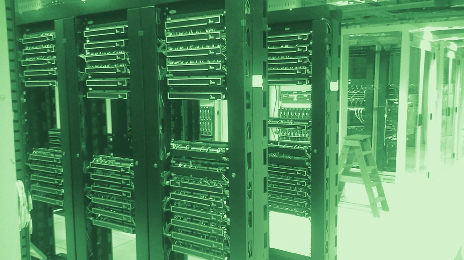 A data-centre aisle: racks of servers receding into the distance.
