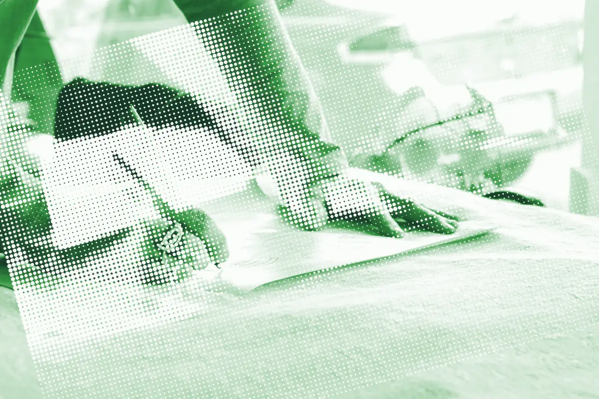 Hands holding a document during a verification step.