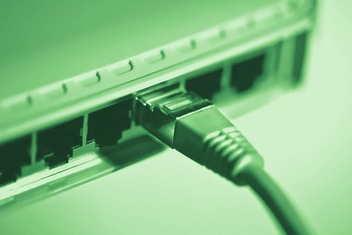 An ethernet cable seated in a network switch port.